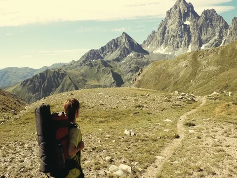 Woman trekking in idyllic mountain landscape Stock Footage