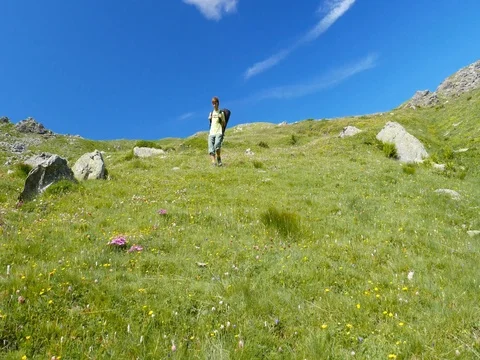 Woman trekking in idyllic mountain landscape Stock Footage