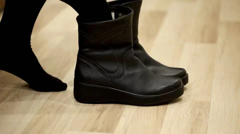 Woman trying on black winter boots Stock Footage 59134214