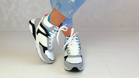 Woman trying on sneakers Stock Footage