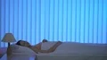 The woman turn on the lamp on the bed. Evening night time 4k or 4k+ Resolution