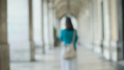 Woman turning to the camera and doing serious look, steadycam shot Stock Footage