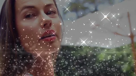 Woman turning left to camera on start, sparkle overlay moving across face, Stock Footage 333301502