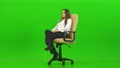 The woman turning on the office chair on the green background 4k or 4k+ Resolution