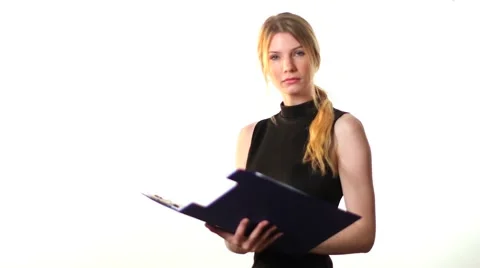 Woman turns to camera and makes notes white back ground Stock Footage 42139348