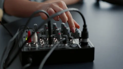 Woman tweaking audio mixer knobs and buttons 스톡 동영상 202396375
