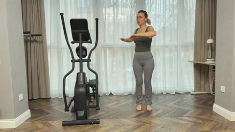 Woman twisting torso side to side with arms bent in front, Concept of core Stock Footage 345686588