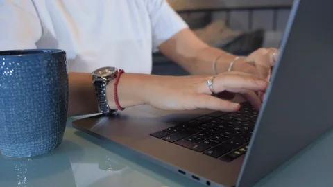 Woman type on notebook computer at home Stock Footage 128598400