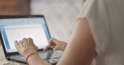 A Woman Types On Her Laptop At Home Stock Footage