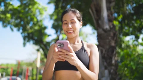 A woman types a message on her mobile phone into an online app after finishing h Stock Footage 253181566