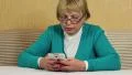 Woman types sms on her mobile phone. Woman with white smartphone HD Footage