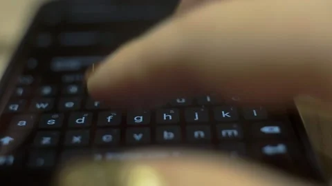 A woman types a text message on her smartphone, taking a macro shot of the smart Stock Footage 143552832