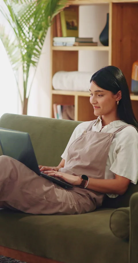 Woman, typing and remote work on couch with laptop, research and laugh for funny Stock Footage 339047656