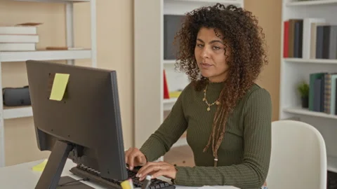 Woman typing at computer with hands on keyboard in home office while later .. Stock Footage 339179793