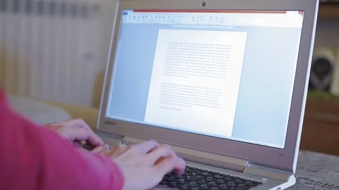 Woman typing on computer while teleworking at home Vídeo Stock 145810580