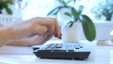 Woman is typing on a keyboard Stock Footage 327658686