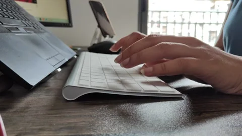 A woman typing on a keyboard while working from home. Indian software developer Stock Footage 246526069
