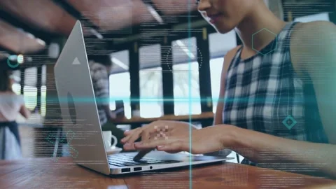 Woman typing on laptop in cafe, causing HUD overlay visualizing technology data Stock Footage 334789003