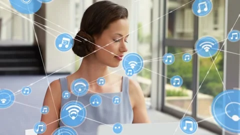 Woman typing on laptop, causing blue icons expanding around her then calling on Stock Footage 333904018