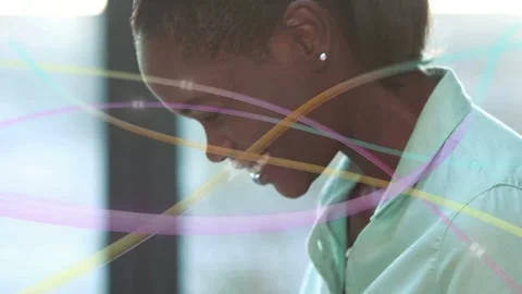 Woman typing laptop causing camera pan, ribbons crossing face, lifting head Stock Footage 333351440