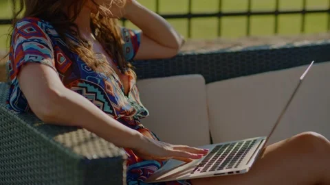 Woman typing on laptop computer outdoor in summer. Stock Footage 156080098