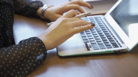 Woman typing on laptop Stock Footage