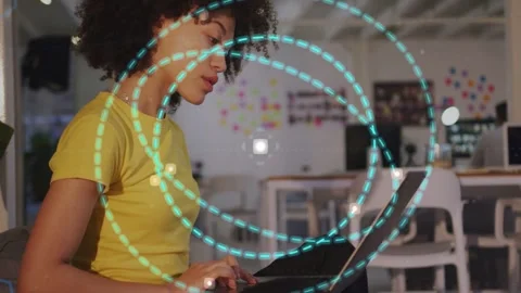 Woman typing on laptop, teal dashed circles expanding from laptop, showing data Stock Footage 332956210
