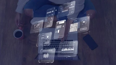 Woman typing on laptop for tech work, initiating floating UI panels, updating Stock Footage 335235987