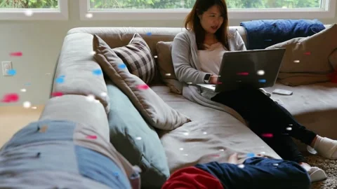 Woman typing on laptop while boy in red moving to see screen, tech particles Stock Footage 333818503