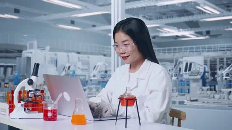 Woman Typing On A Laptop While Working With Microscope And Test Tube In The Lab Video stock 270224173