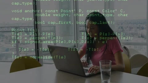 Woman typing at laptop by windows, causing green code overlay growing across Stock Footage 326974466