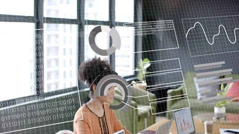 Woman typing laptop by windows causing binary matrix and charts moving right for Stock Footage 333132571