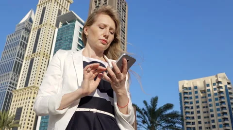 Woman typing message on her cell phone Video stock 60969376