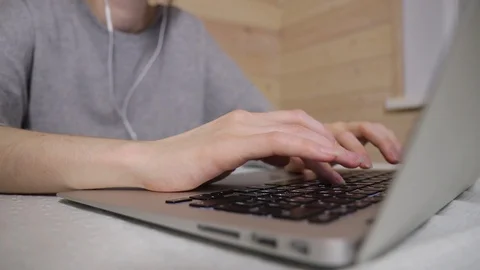Woman typing a message on a laptop, working during isolation period at home HD Video stock 129691237