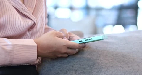 Woman typing message on smartphone while sitting on sofa at home, chatting,.. Stock Footage 340614977