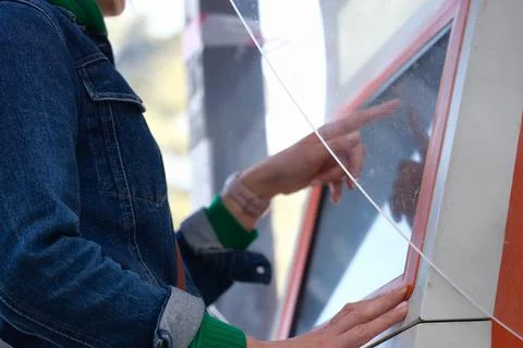 Woman typing pin code on screen of ATM closeup Stock Photos