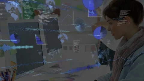 Woman typing at shared desk, generating charts and code overlays for analyzing Stock Footage 333526105