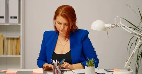 Woman typing on tablet transferring data online. Stock Photos