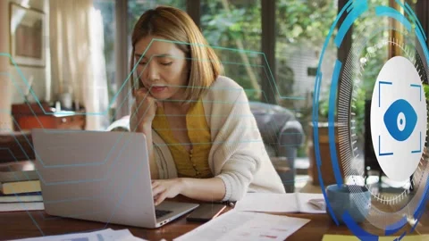 Woman typing for tech work, eye-icon HUD and circuit lines sweeping over laptop Stock Footage 334338077