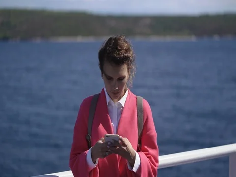 Woman typing text on smartphone using app and travel on a ferry Stock Footage 80686062