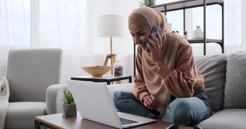 Woman typing using laptop while talking on mobile Stock Footage 164543855