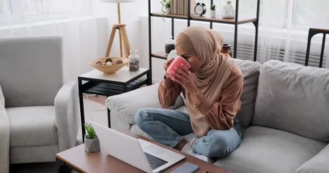 Woman typing using laptop while talking on mobile relaxing on sofa Video stock 164544095
