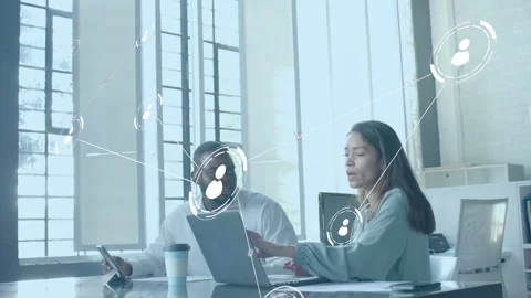 Woman typing while man tapping tablet, initiating network nodes expanding over Stock Footage 336714158