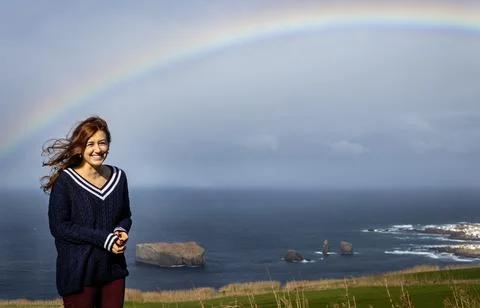 Woman under rainbow. Stock Photos