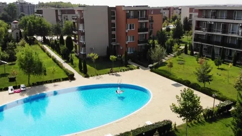 Woman on unicorn pool float in pool. Enjoying summer vacations from above Stock Footage 266799543
