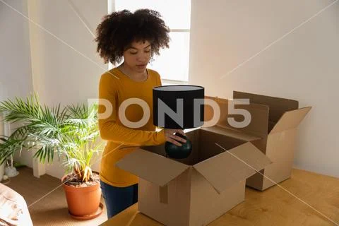 Woman Unpacking Boxes In An Office