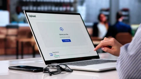 Woman Uploading Files To Cloud Storage On Laptop Computer At Coffee Shop 스톡 동영상 334524658