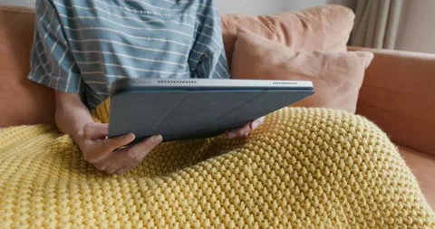 Woman use of digital tablet computer at home Stock Footage 132091719