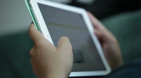 Woman use mobile device while relaxing on a sofa. Stock Footage 64050616