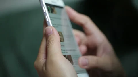 Woman use mobile device while relaxing on a sofa. Video stock 64050624